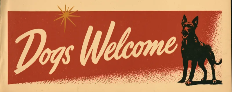 Dogs Welcome — the resort's painted banner, a dog in silhouette beside the lettering.